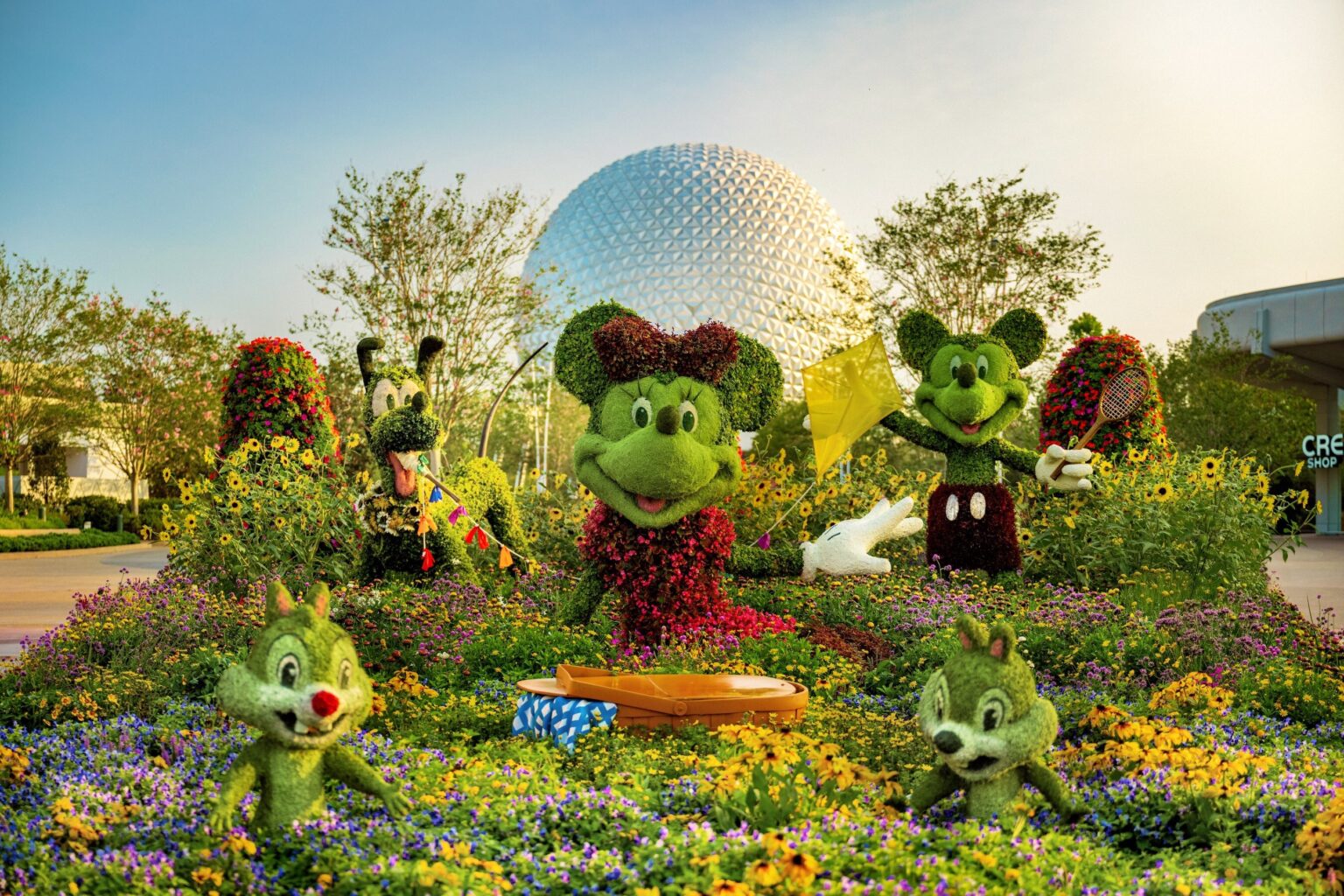 Multiple Disney-themed topiaries modeled after Mickey Mouse and friends are seen in this promotional image for Walt Disney World