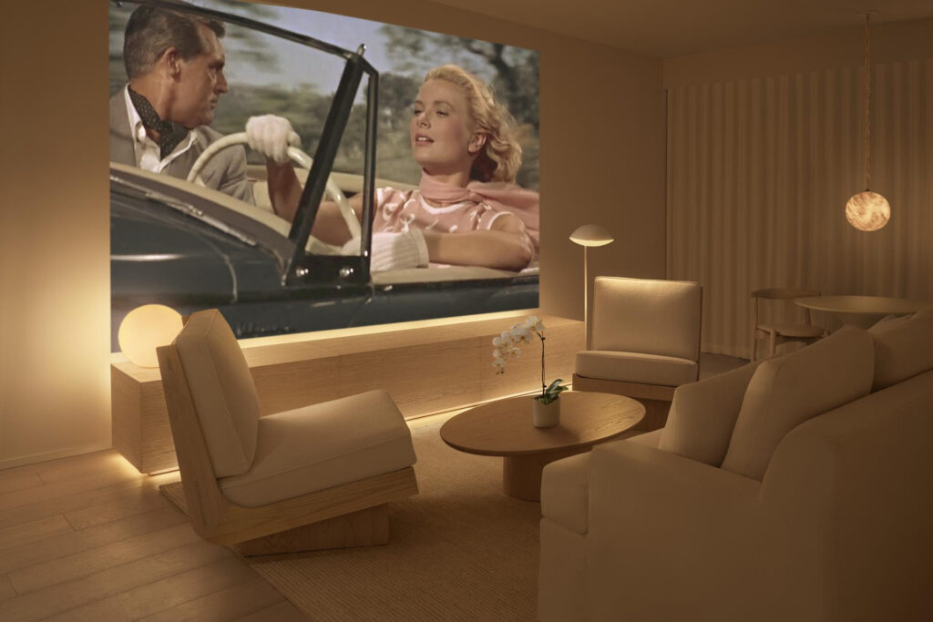 This image rendering shows the interior of a guest room with a large screening projector at Public West Hollywood, a boutique luxury hotel opening in Los Angeles in July 2026. (Image courtesy of Public West Hollywood)