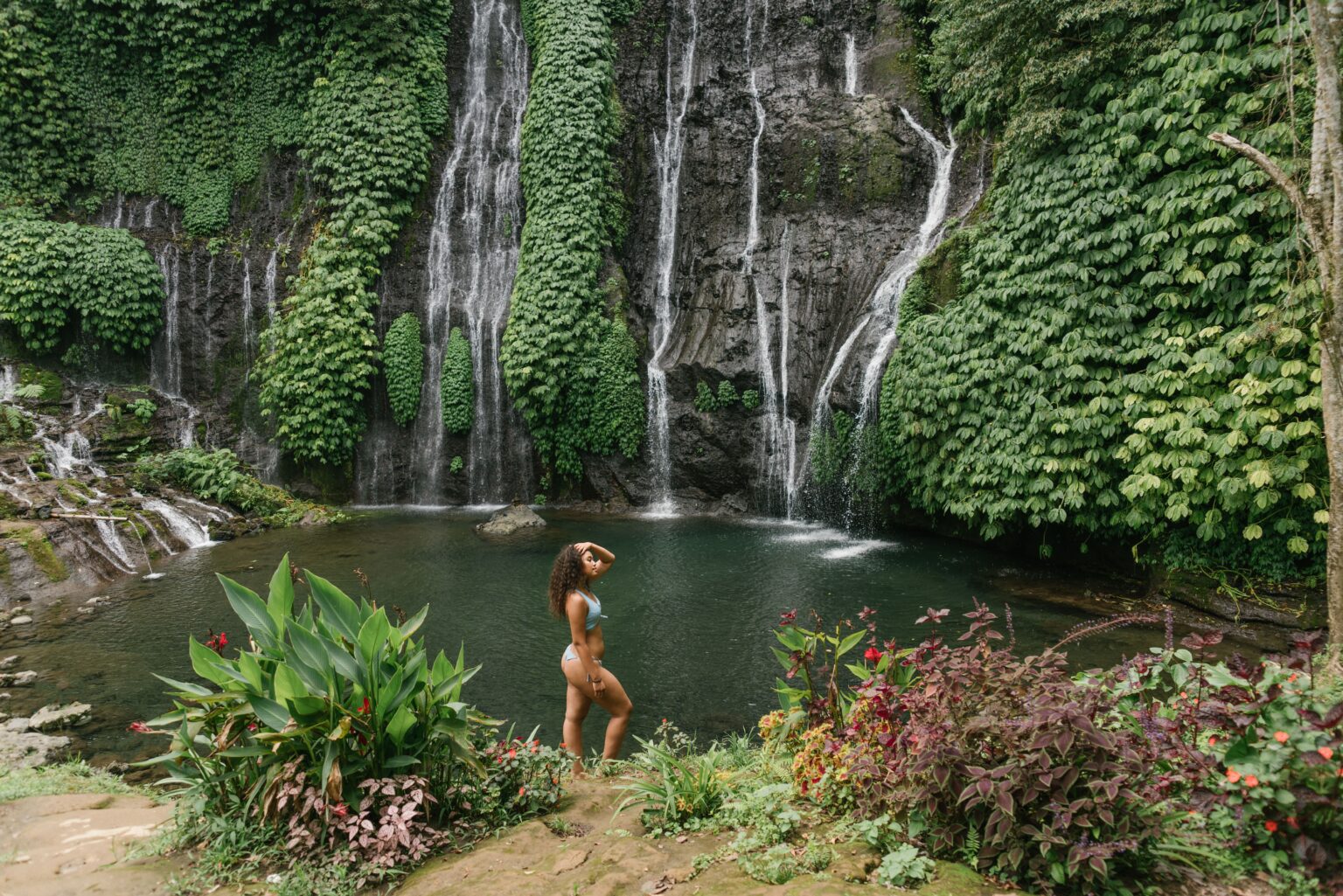 Bali cracking down on wannabe influencers for violating tourist visa rules A woman in a bikini poses next to a waterfall in Bali, Indonesia, in this 2020 photo from Pexels.com