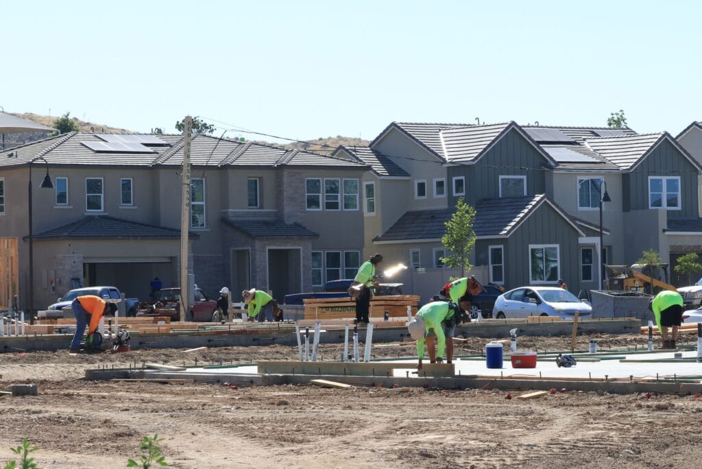 Construction workers lay down a foundation at a home development in this June 2023 photo. (Pexels.com)