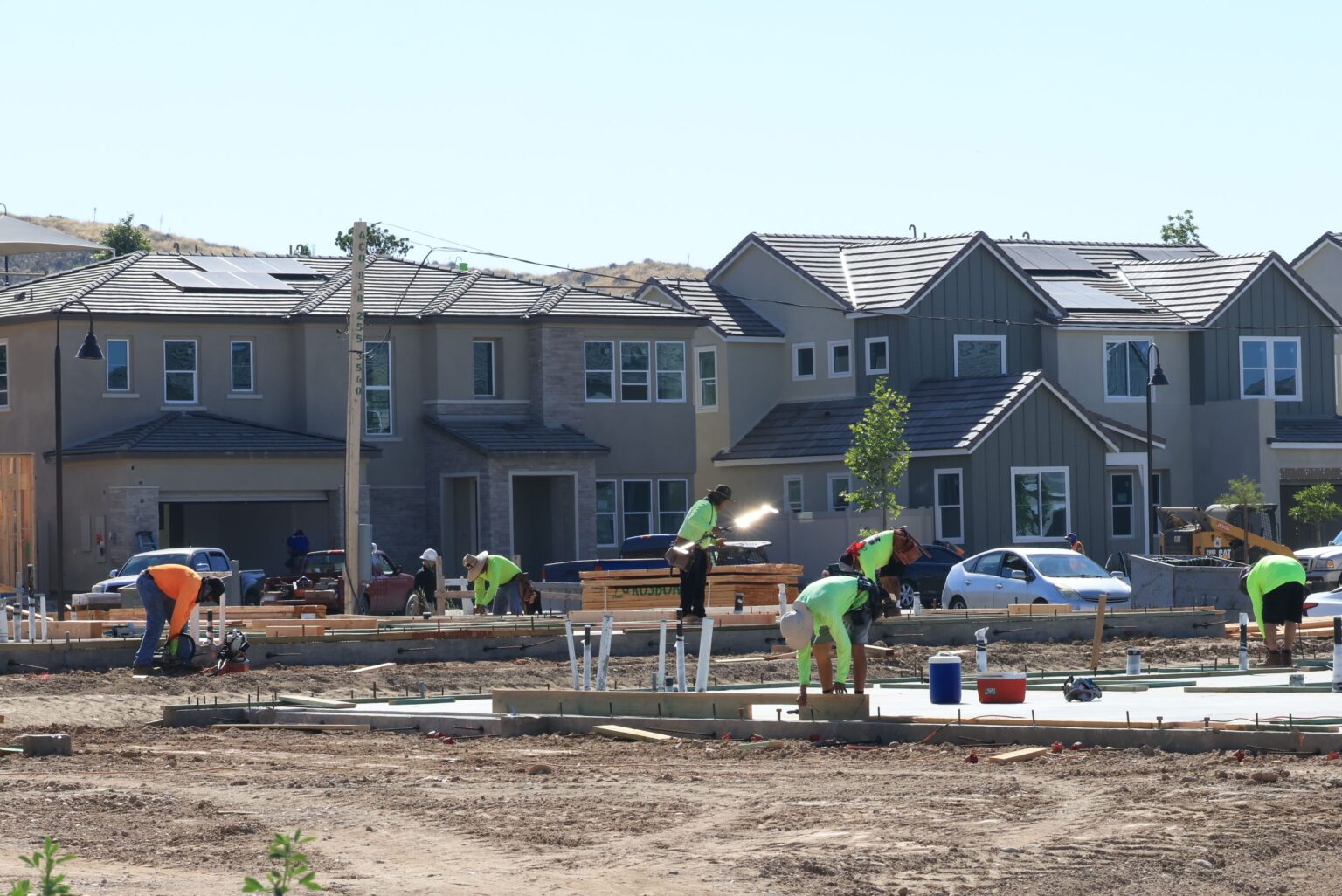 Construction workers lay down a foundation at a home development in this June 2023 photo. New analysis from Zillow shows building more homes in 2024 eased the housing crisis. (Pexels.com)
