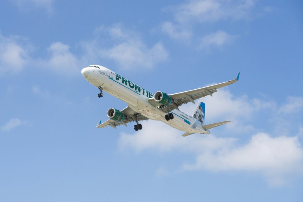 A Frontier Airlines jet flies over O'Hare International Airport in Chicago in this June 2024 photo from Unsplash.com