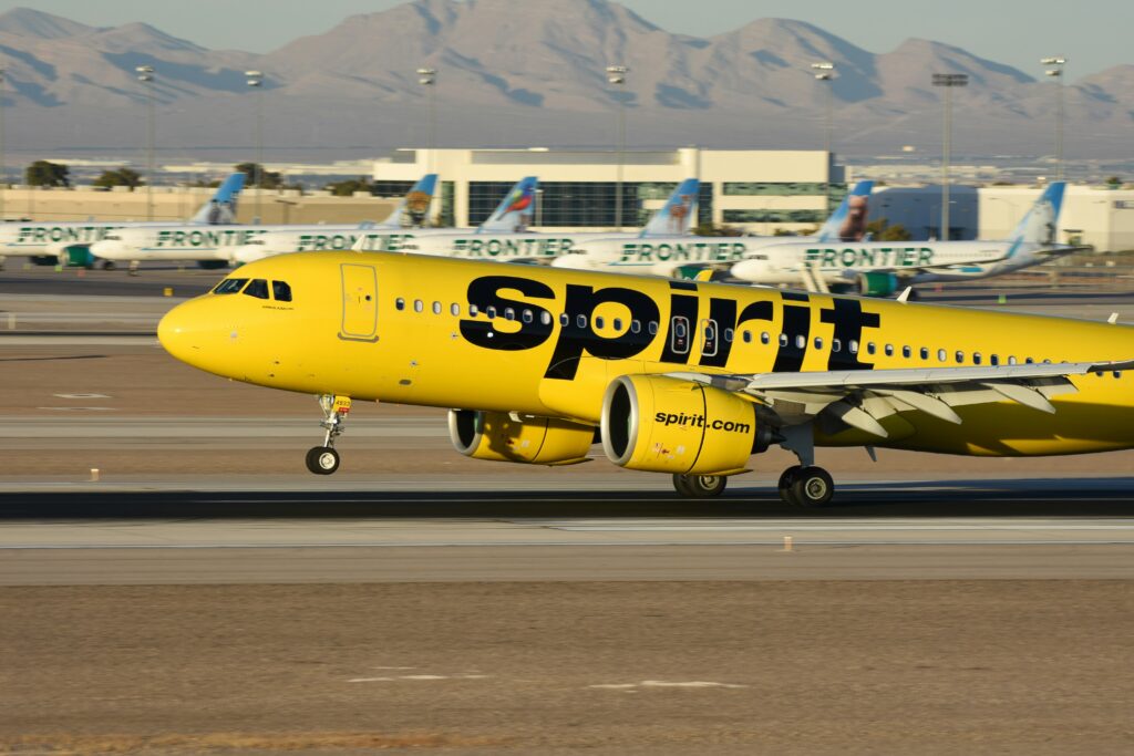 Spirit Airlines A320neo landing in Las Vegas with Frontier Airlines jets in the background at Harry Reid International Airport on February 15, 2025. (David Syphers/Unsplash.com)