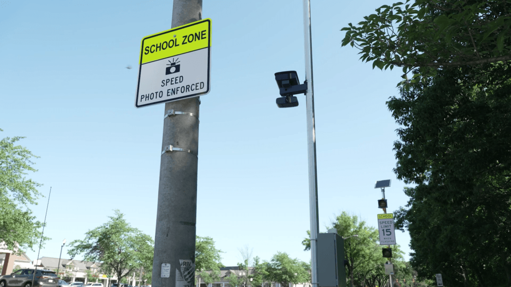 B-roll from Verra Mobility shows a sign warning of a speed camera in a school zone with a speed camera visible in the background in this undated promotional photo. Similar speed cameras will be deployed in Los Angeles in summer 2026. (Verra Mobility)