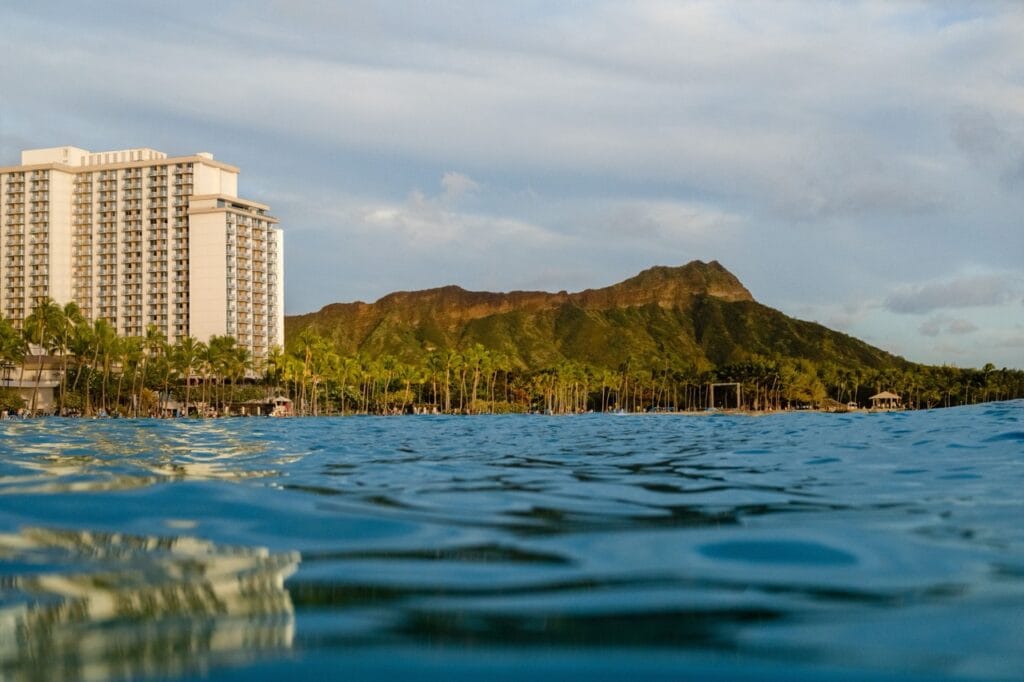 Exterior of the Twin Fin resort in Honolulu is shown left of frame with the iconic Diamondhead peak in the center in this undated promotional image. (Courtesy Image)