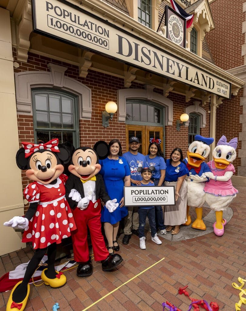 A milestone as Disneyland Resort commemorates welcoming one billion guests to Disneyland park and Disney California Adventure park in Anaheim, Calif., on Friday, July 3, 2026;. The honorary one billionth guest, Andres Robles, 8, of Arizona and his parents joined with the Disney Ambassadors to unveil updated sign that reads “Population 1,000,000,000”. (Christian Thompson/Disneyland Resort)