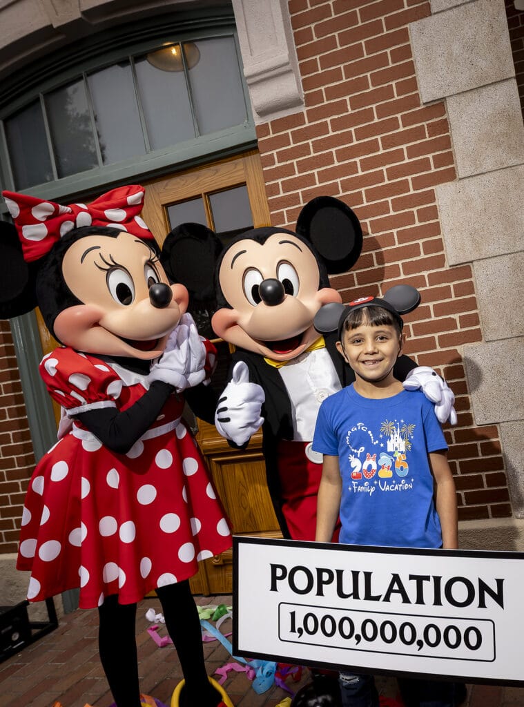 A milestone as Disneyland Resort commemorates welcoming one billion guests to Disneyland park and Disney California Adventure park in Anaheim, Calif., on Friday, July 3, 2026;. The honorary one billionth guest, Andres Robles, 8, of Arizona and his parents joined with the Disney Ambassadors to unveil updated sign that reads “Population 1,000,000,000”. (Christian Thompson/Disneyland Resort)