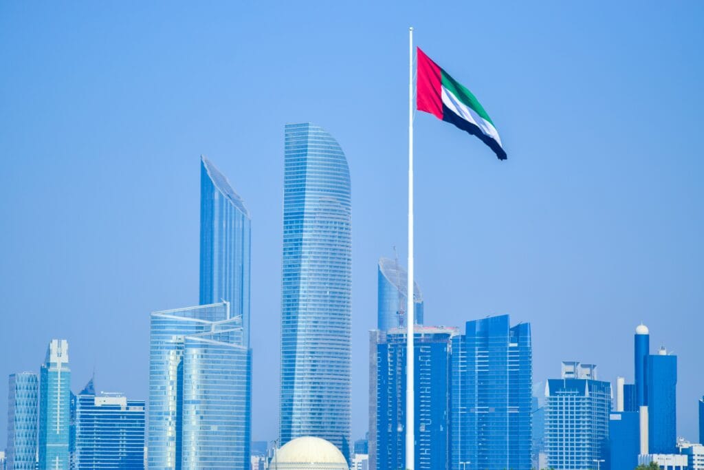 The flag of the United Arab Emirates (UAE) flies in front of the Abu Dhabi skyline in this October 2020 photo from Pexels.com.