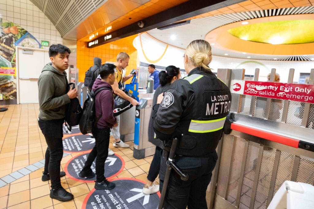 LA Metro security helps riders navigate the tap-to-exit system at the North Hollywood Metro station in May 2024. (LA Metro)