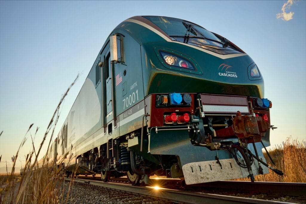 An Amtrak Airo train with the Cascades route color scheme and branding is seen in this undated promotional image from Amtrak.