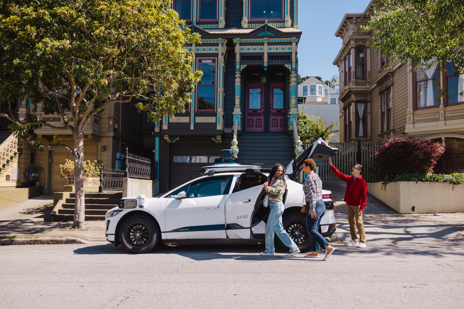 Waymo will pay riders who use public transit Riders are seen getting into a driverless taxi in this promotional image from Waymo.